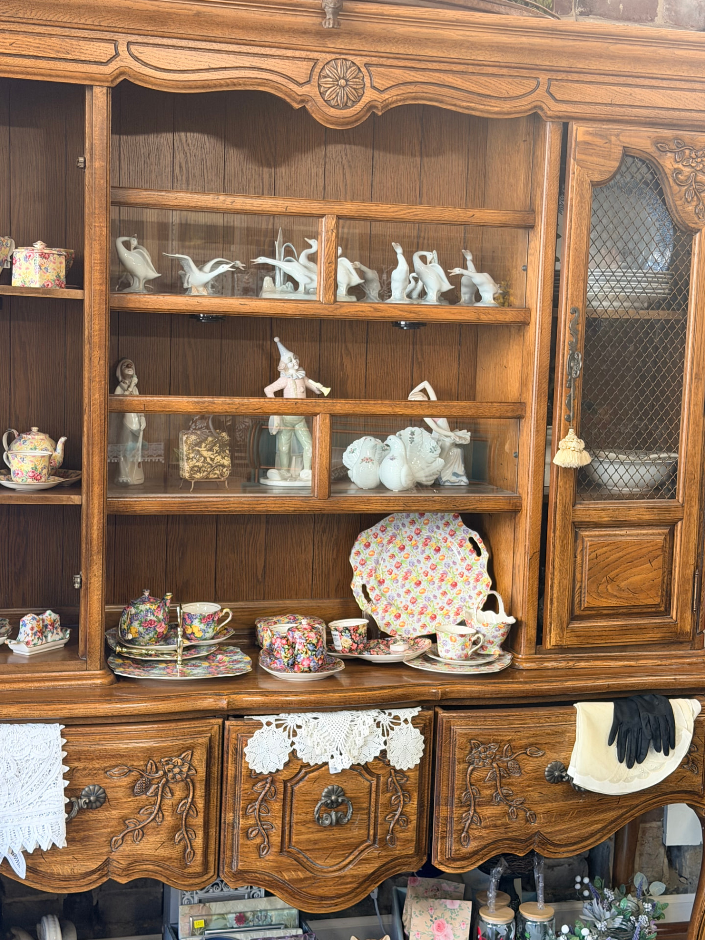 Antique oak hutch filled with floral chintz china and porcelain figurines